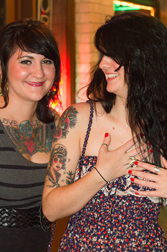 Two women on sixth street model their "ink"